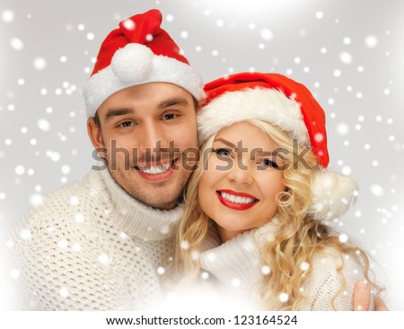 picture of family couple in sweaters and santa\'s hats