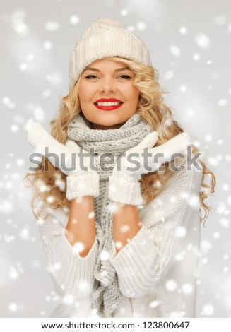 bright picture of beautiful woman in hat, muffler and mittens..