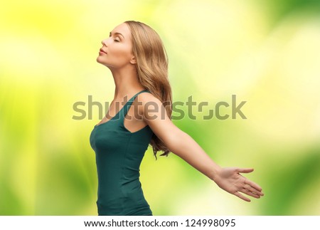 picture of calm and serious woman spreading hands.