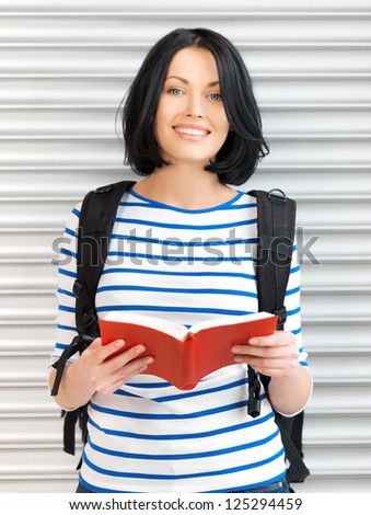 bright picture of attractive woman with bag and book..