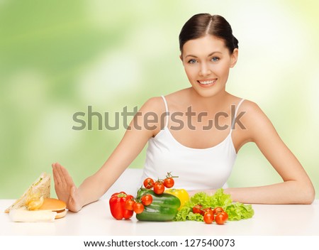 picture of beautiful woman with hamburger and vegetables