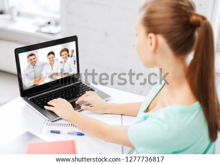 business, education and technology concept - woman or student having video interview with employer or teacher team on laptop computer at home or office