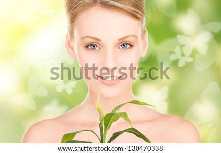 woman with sprout and butterflies over green background