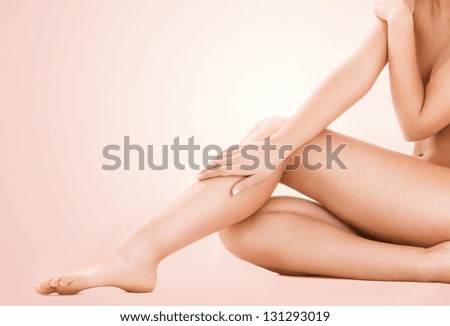 picture of healthy naked woman legs over beige background