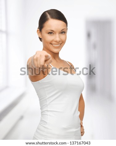 happy woman in blank white t-shirt pointing her finger