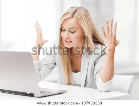 picture of angry businesswoman with laptop at work