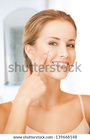 picture of beautiful woman pointing to nose