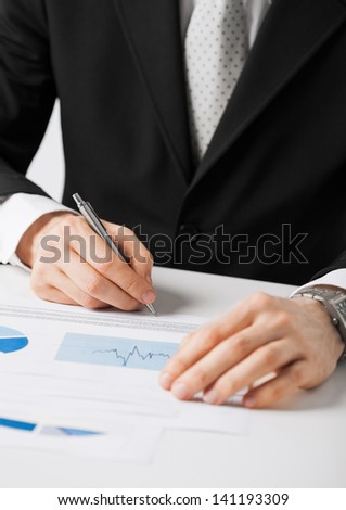 picture of businessman working and signing paper
