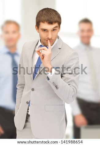 bright picture of handsome man with finger on lips