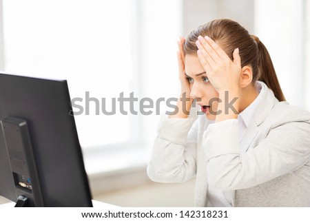 picture of stressed student with computer in office