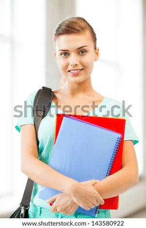 happy student girl with school bag and notebooks
