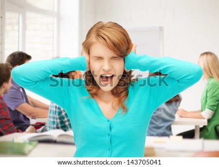 student closing her ears and screaming at school
