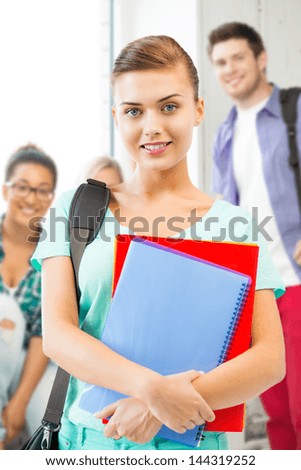 happy student girl with school bag and notebooks at school
