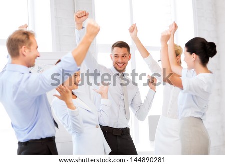 Picture Of Happy Business Team Celebrating Victory In Office