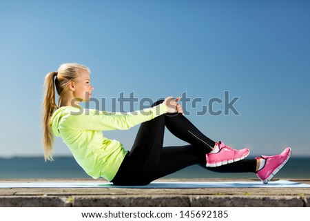 Sport And Lifestyle Concept - Woman Doing Sports Outdoors
