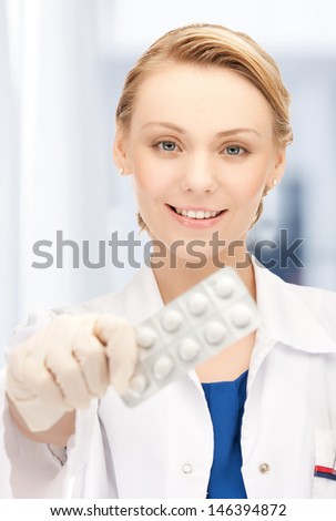 healthcare and medical concept - doctor with blister pack of pills in hospital