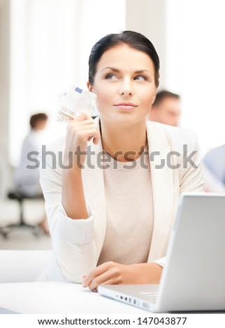 business, money and internet - pensive businesswoman with cash money in office