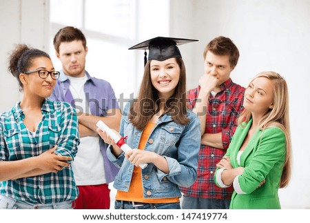 education and competition concept - girl in graduation cap with certificate and students
