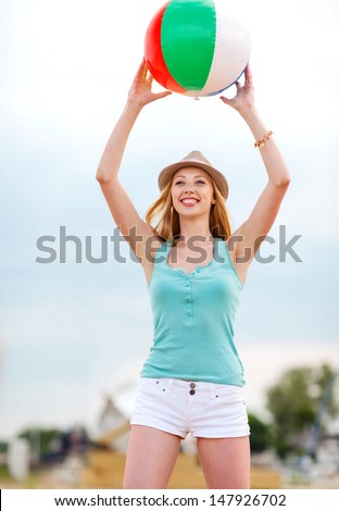 summer holidays, vacation and beach activities - girl playing ball on the beach