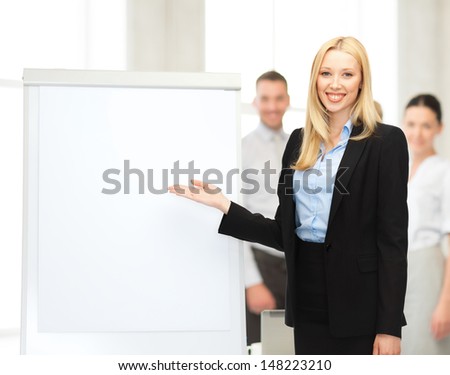 bussiness, meeting and education - businesswoman with flipchart in office