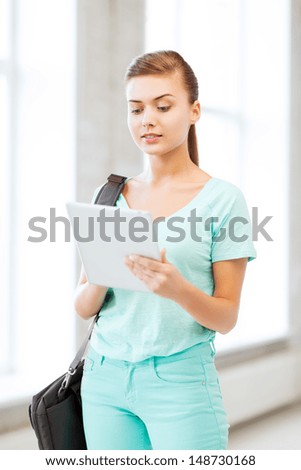 education and technology - smiling student with tablet pc in college