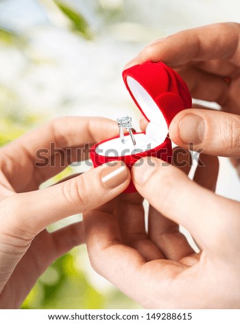 Couple Hands With Wedding Ring And Gift Box