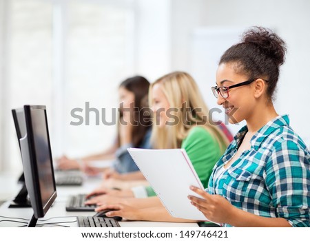 education concept - african student with computer studying at school
