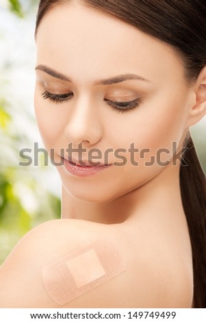 medical, eco and bio concept - woman with medical patch or plaster