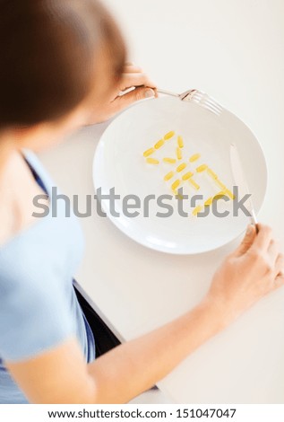sport, healthcare and diet concept - woman with plate and meds
