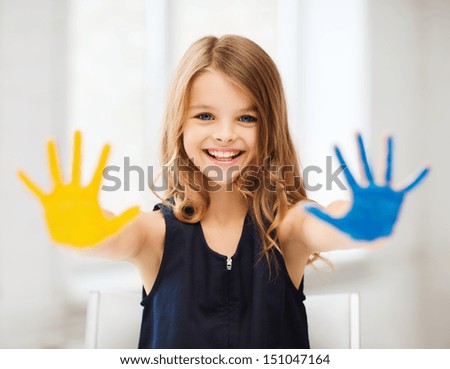 Education, School, Art And Painitng Concept - Little Student Girl Showing Painted Hands At School