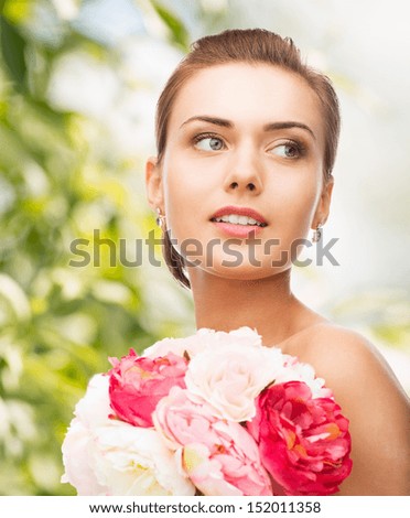 holidays, beauty and jewelry - woman with diamond earrings and flowers
