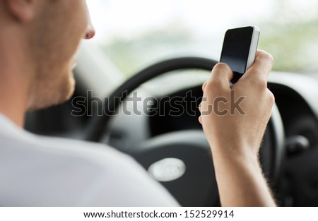 Transportation And Vehicle Concept - Man Using Phone While Driving The Car