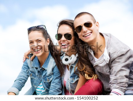 Summer Holidays And Teenage Concept - Group Of Teenagers Hanging Outside
