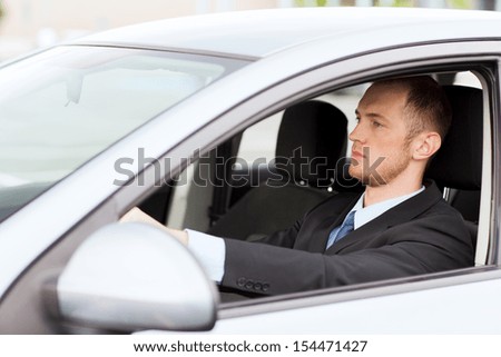 transportation and vehicle concept - businessman driving a car