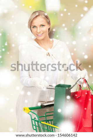 sale, christmas, x-mas and holidays concept - lovely woman with shopping bags