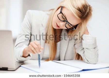 Business And Education Concept - Indoor Picture Of Bored And Tired Woman Taking Notes