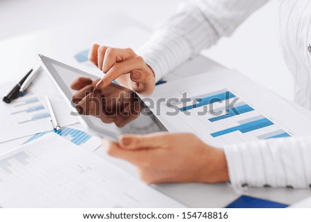 business, office, school and education concept - woman with tablet pc and chart papers