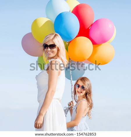 summer holidays, celebration, family, children and people concept - mother and child with colorful balloons