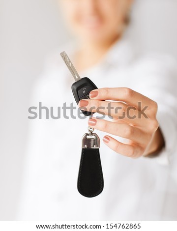 Business, Banking, Vehicle, Rental, Automotive Concept - Woman Hand Holding Car Key