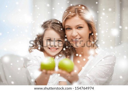 Family, Children, Christmas, X-Mas, Love Concept - Mother And Daughter Holding Green Apples