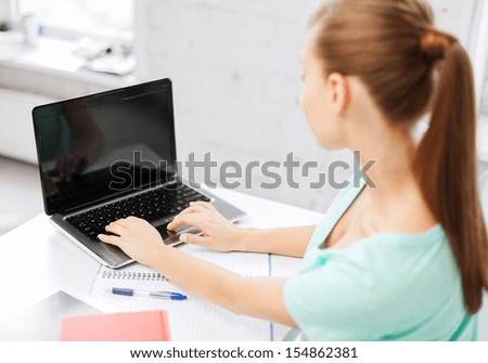 business, office, school and education concept - businesswoman working on laptop with blank screen