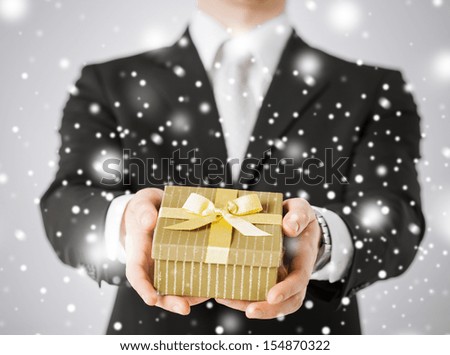 love, romance, holiday, celebration concept - man giving gift box