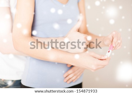 love, romance, family concept - woman and man hands with pregnancy test