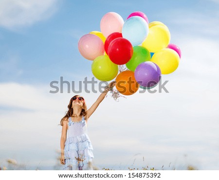 Summer Holidays, Celebration, Family, Children And People Concept - Happy Girl With Colorful Balloons