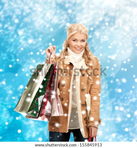 holidays, sale, shopping, christmas concept - beautiful woman in winter clothes with shopping bags