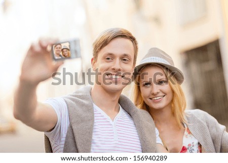 summer holidays, travel, vacation, tourism and dating concept - travelling couple taking selfie with digital camera