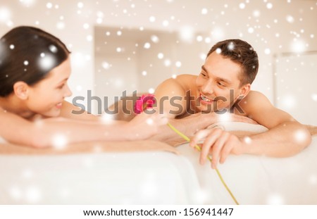 health and beauty, love, romance concept - couple in spa salon lying on the massage desks