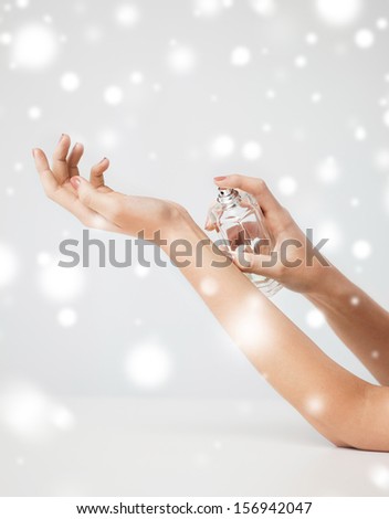 Health And Beauty Concept - Woman Hands Spraying Perfume