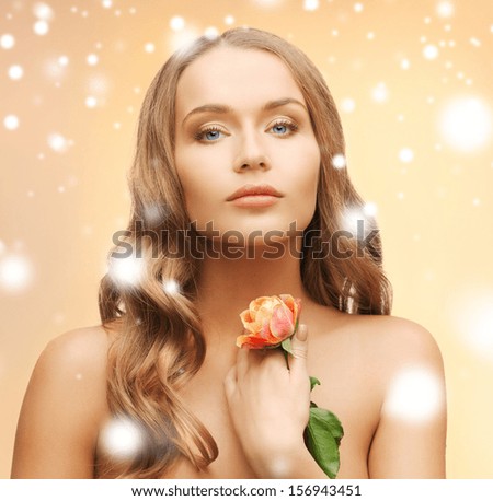 health and beauty concept - relaxed woman with rose flower