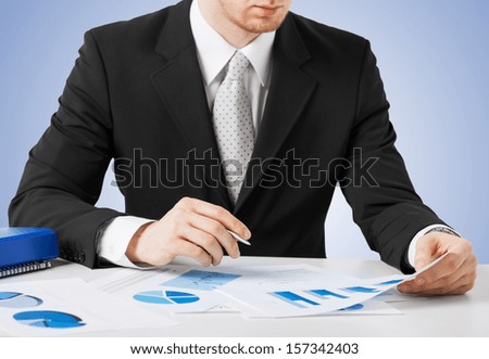 office, buisness, legal concept - businessman working and signing with papers